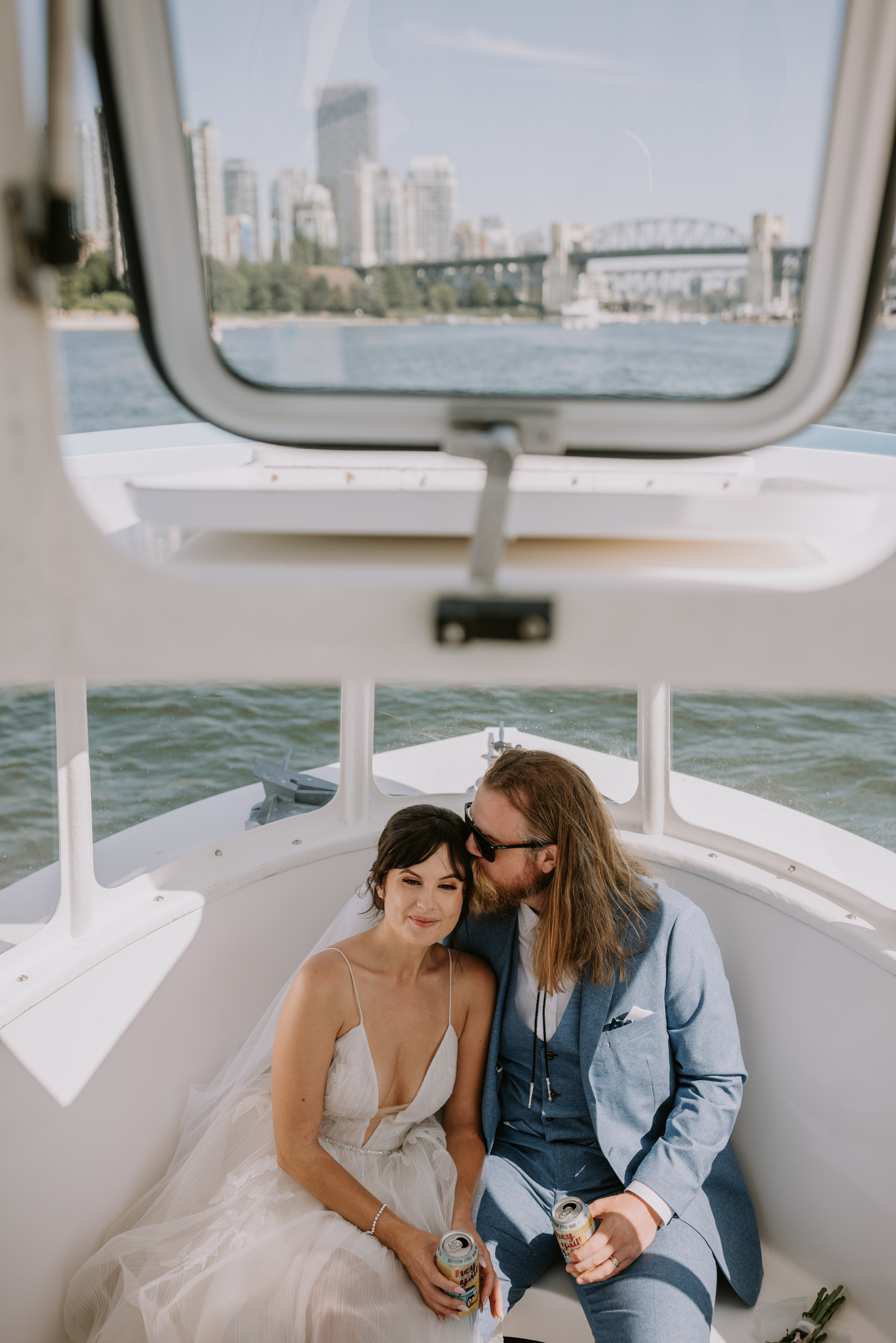 Wedding couple taking a water taxi to their reception on a bright summer day